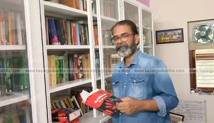 Pekkadam Bhaskaran Mash standing near his extensive library of books.