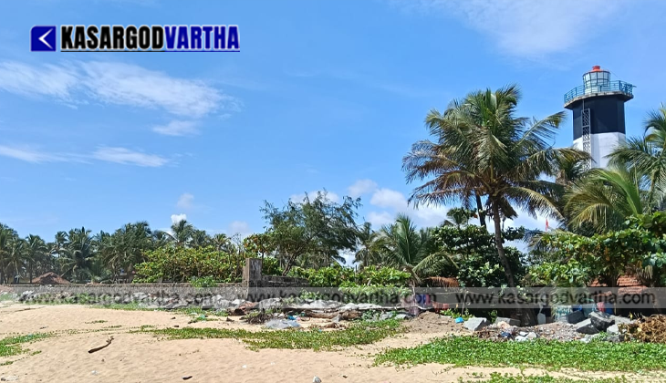 Plastic waste bottles and marine debris washed ashore on a sandy beach due to strong pre-monsoon waves.