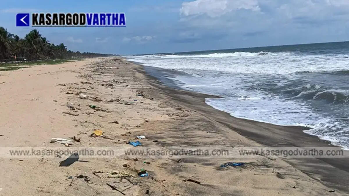  Plastic waste bottles and marine debris washed ashore on a sandy beach due to strong pre-monsoon waves.