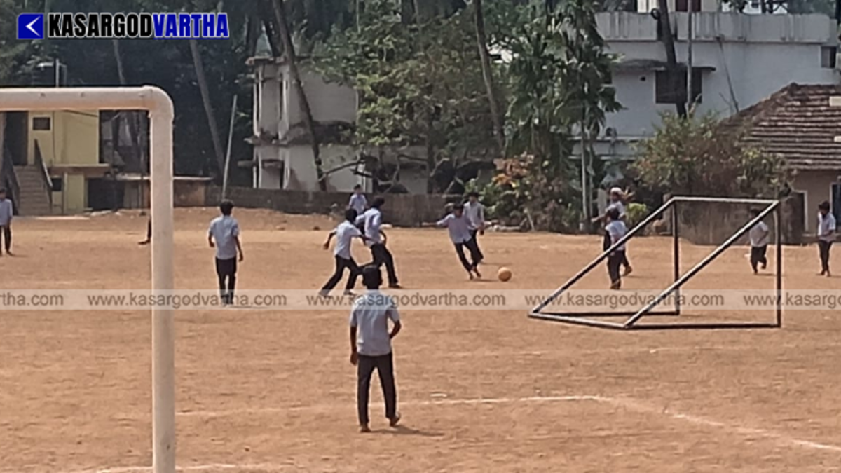  Students playing in a sunny school playground during peak hours.