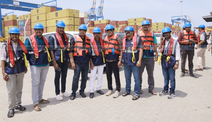 An image of the Vizhinjam International Seaport with cargo ships and cranes.