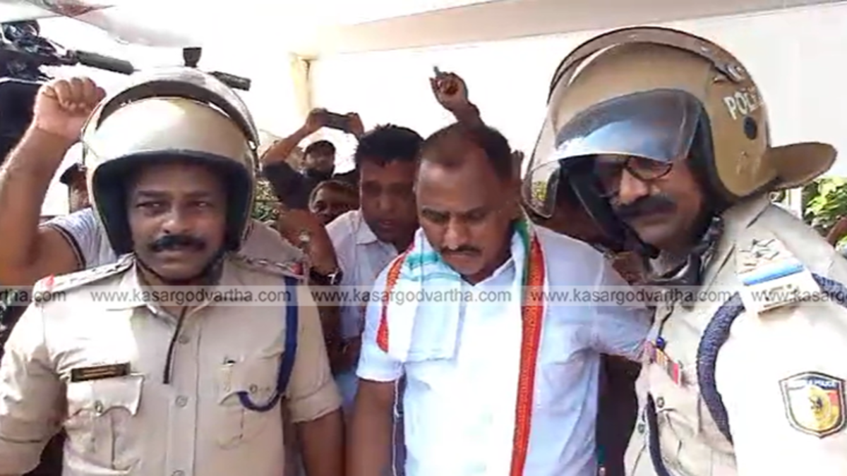 Police arresting Manjeshwaram MLA AKM Ashraf at Kumbala toll protest site.