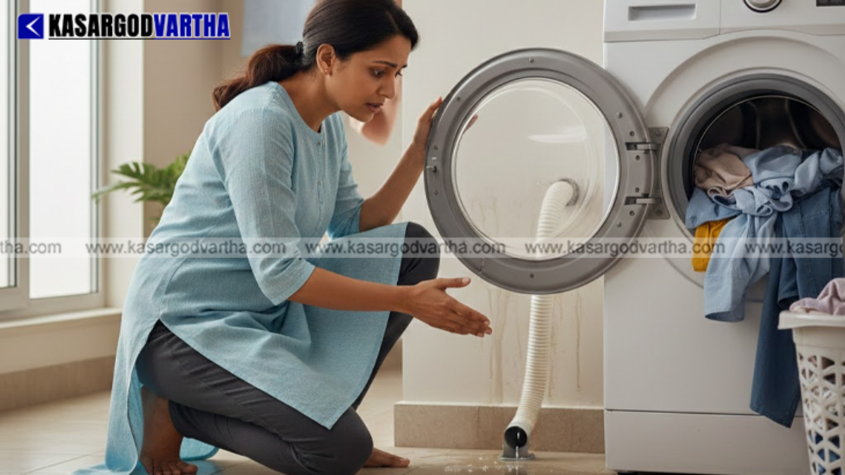 A clogged washing machine drain pipe causing a water leak.