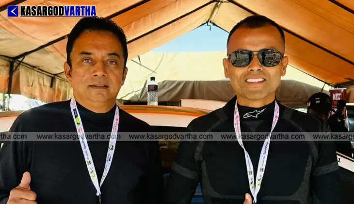 Text: Indian rally pair Naveen Puligilla and Musa Sherif posing with their rally car in Kenya