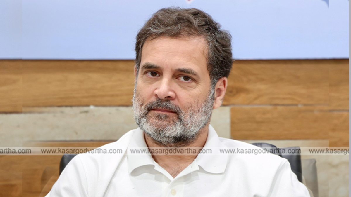 Rahul Gandhi addressing a crowd, with security personnel nearby.