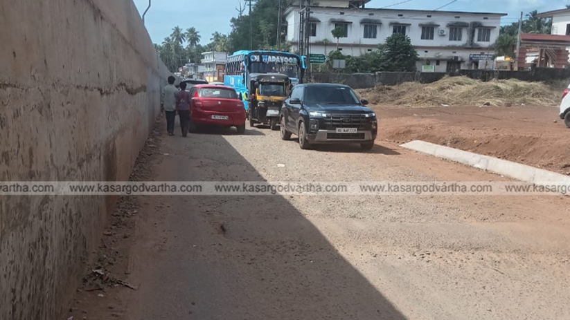 Traffic congestion on the unfinished narrow service road in Cherkala.