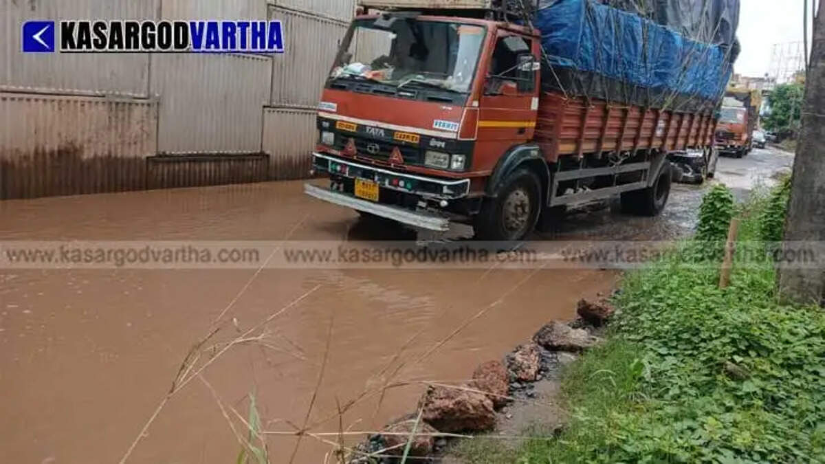 Severe waterlogging and mud at Nileshwaram Market Junction spark protests against construction company over incomplete service roads.