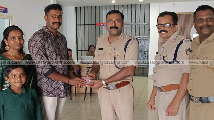 Police officer returning a wallet to a civilian