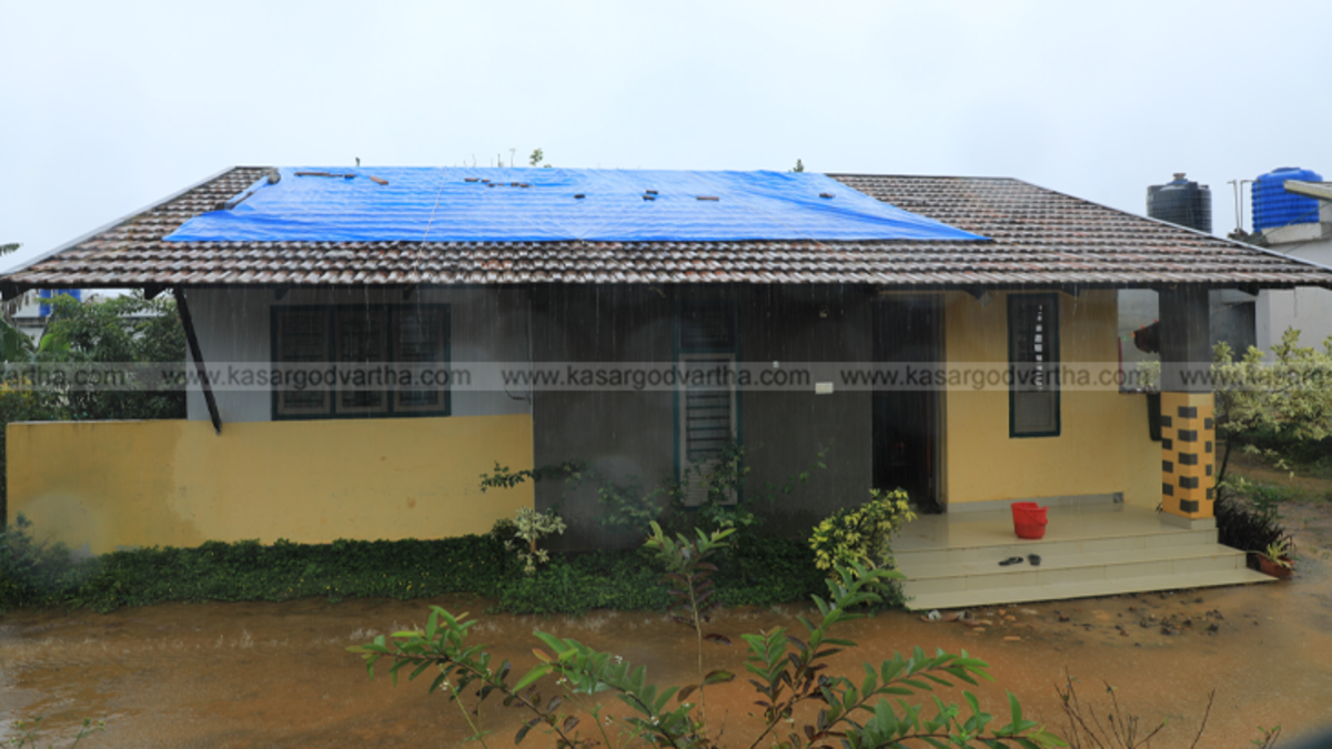 Puthumala Harsham colony house with a bucket placed to catch rainwater leaking from the roof.