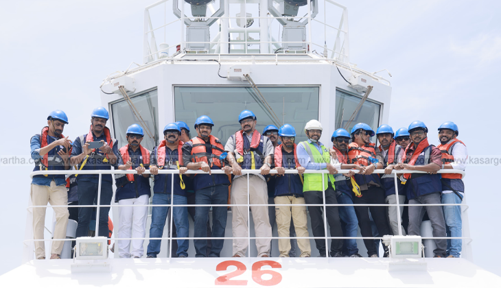 An image of the Vizhinjam International Seaport with cargo ships and cranes.