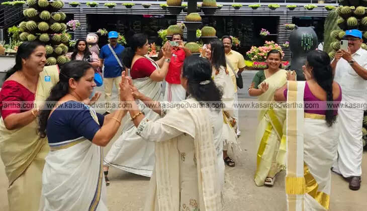 A group of Malayali women performing a Thiruvathira dance in a beautiful park in Thailand.