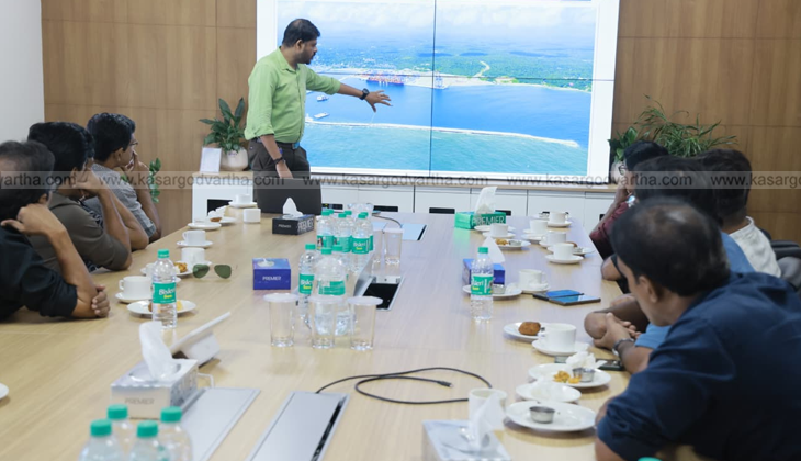 An image of the Vizhinjam International Seaport with cargo ships and cranes.
