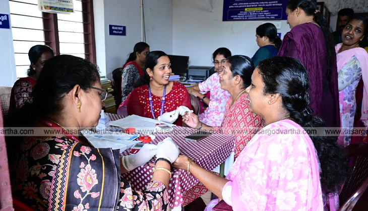 A group of women receiving medical checkups at a health clinic in Kasaragod.