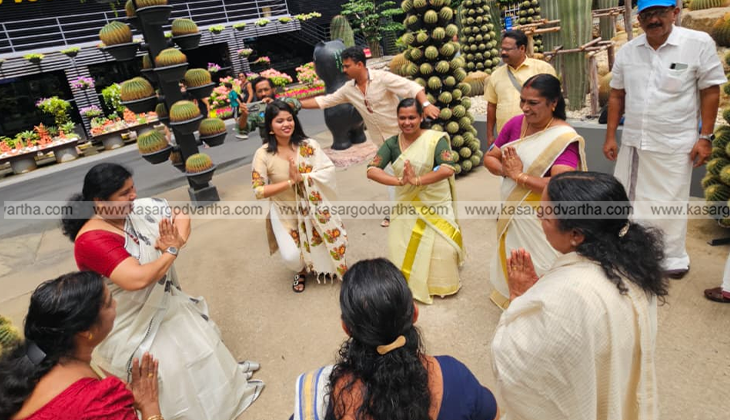 A group of Malayali women performing a Thiruvathira dance in a beautiful park in Thailand.