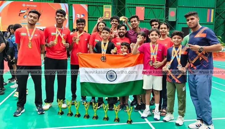 Iss Al Din, a young badminton player from Kasaragod, posing with his medals.