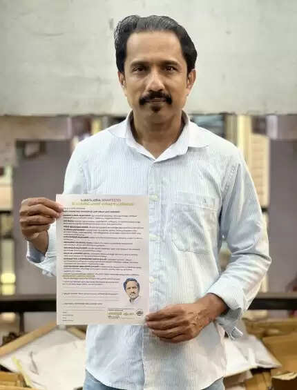  Independent candidate M. Hussain holding his development manifesto.