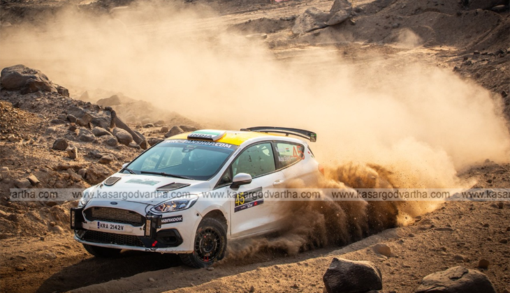Indian rally duo Musa Sherif and Naveen Puligilla on WRC podium with the Indian flag.