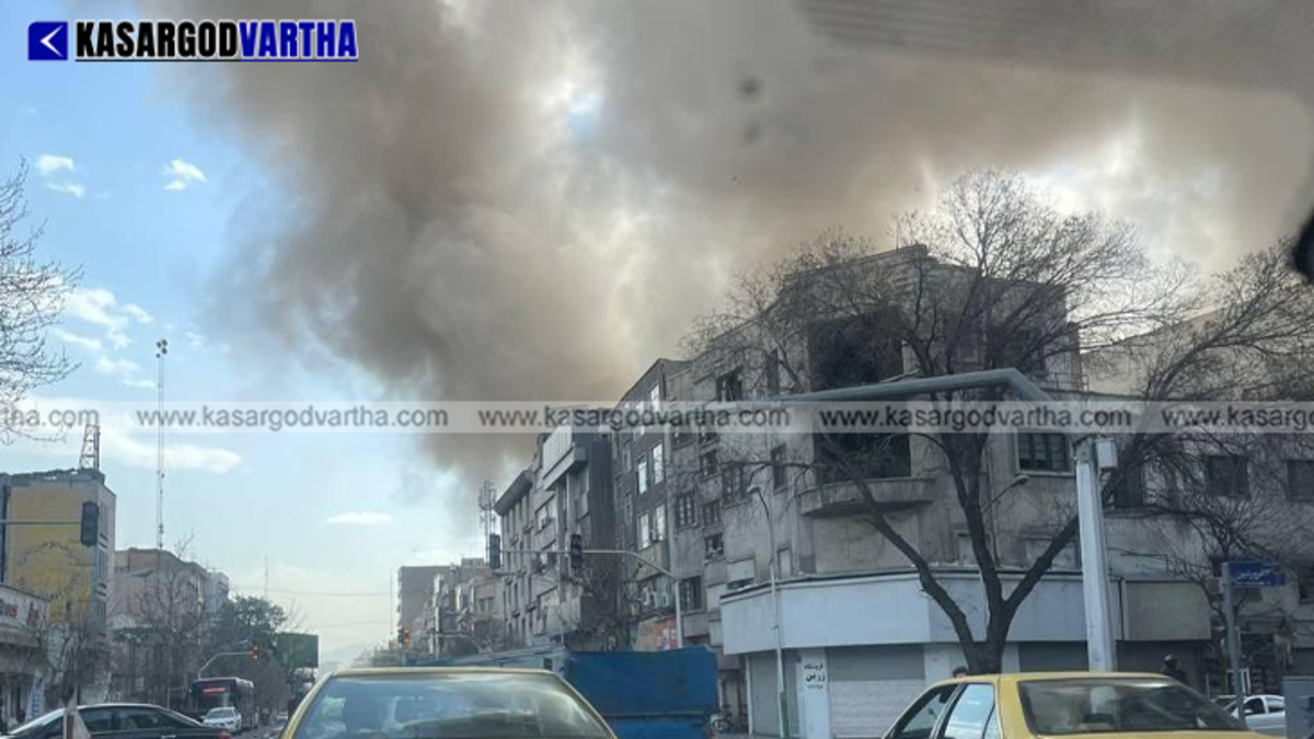 Smoke rising from buildings in central Tehran after military air strikes.