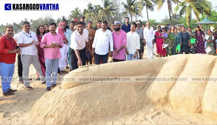 Massive sand sculpture of a voting finger at Pallikkara Beach Kasaragod.