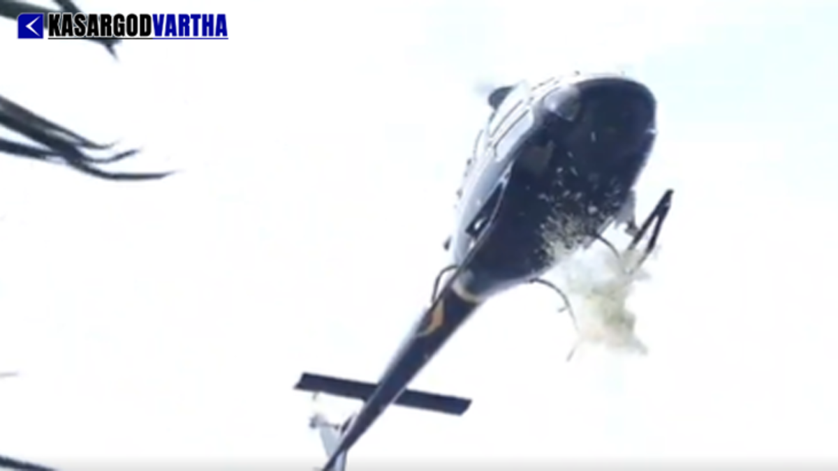 A helicopter hovering over a baby shower event and showering flower petals.