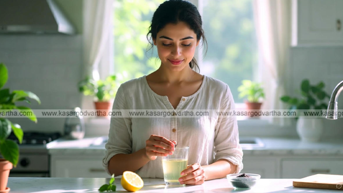 Glass of lemon water with black salt (Kala Namak) on a wooden table.