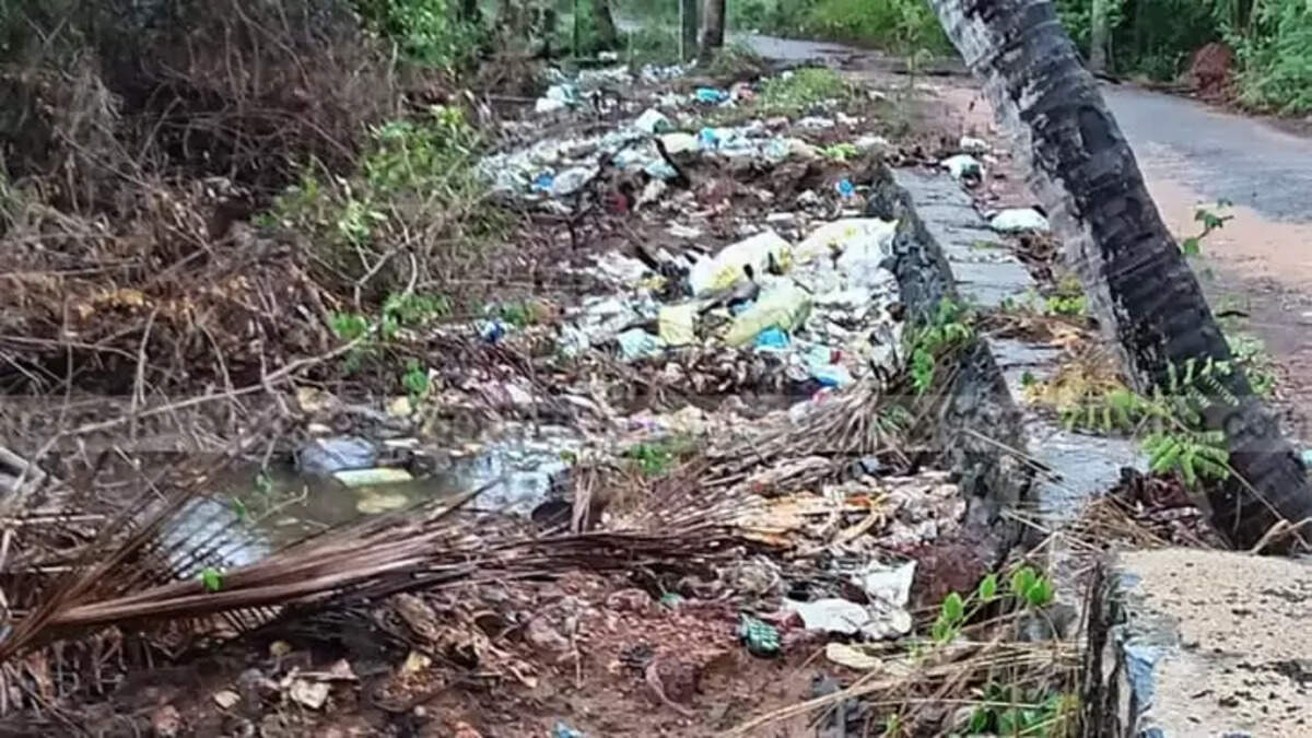 Piles of plastic waste and garbage dumped along the Mogral riverside and coastline in Kasaragod, indicating repeated pollution despite cleanup efforts.