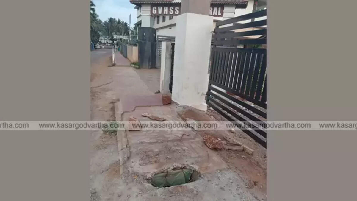 Damaged concrete slab at Mogral School gate posing danger.