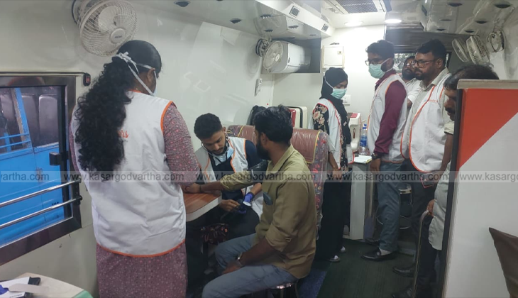 A picture of the Aster MIMS mobile medical van parked in a rural area for a health camp.