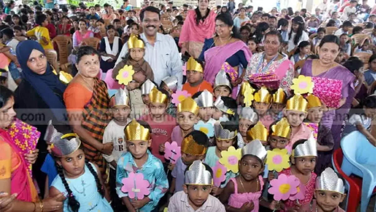 Dr. D Sajith Babu interacting with school children at a Praveshanolsavam event in Kasaragod.