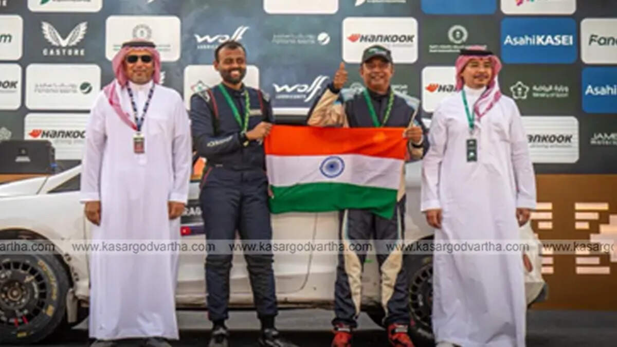 Indian rally duo Musa Sherif and Naveen Puligilla on WRC podium with the Indian flag.