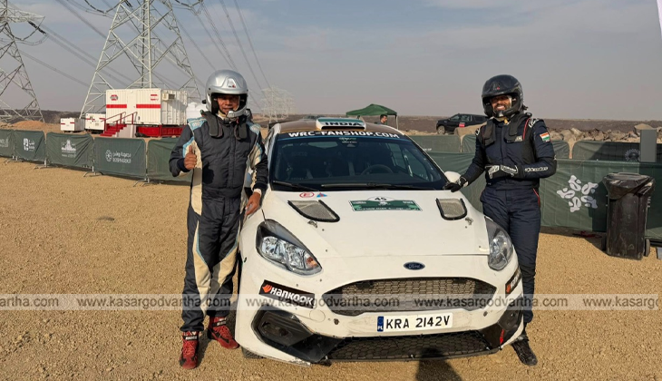  Indian rally duo Musa Sherif and Naveen Puligilla on WRC podium with the Indian flag.