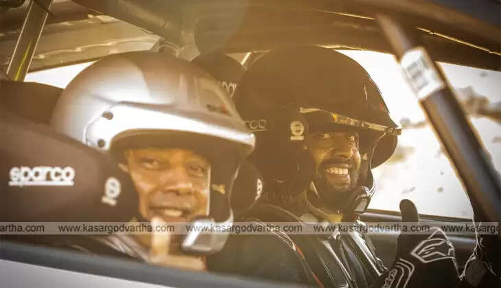 Indian rally duo Musa Sherif and Naveen Puligilla on WRC podium with the Indian flag.