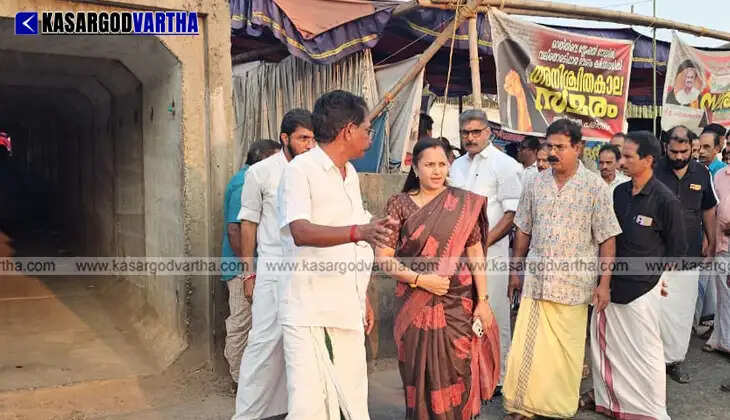 Protesters sitting under a tent holding banners for a complete underpass.