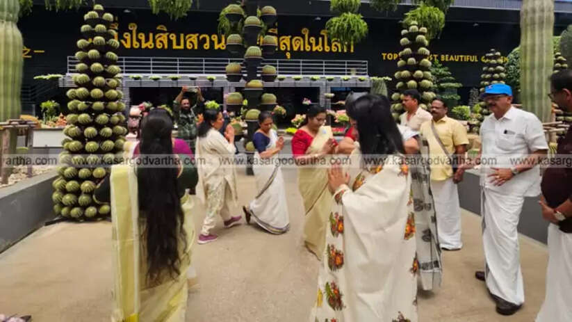 A group of Malayali women performing a Thiruvathira dance in a beautiful park in Thailand.