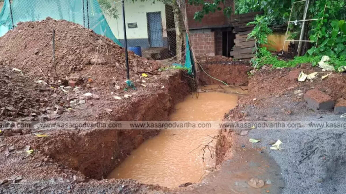 Open toilet pit at Mogral School ground, posing danger to students.