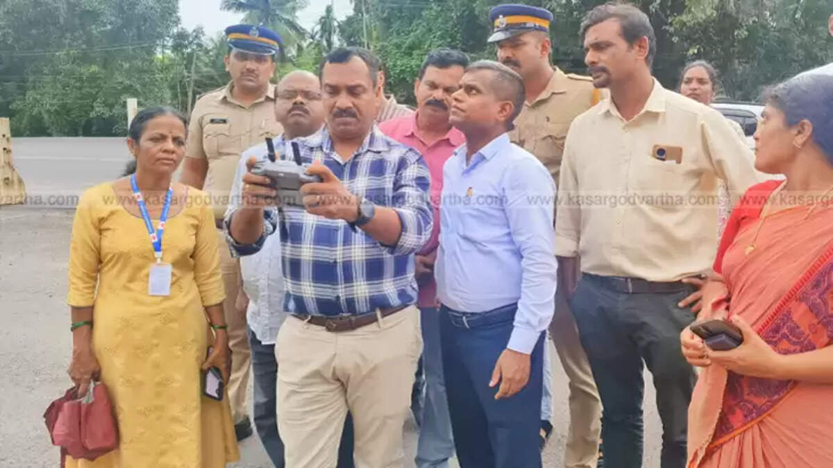 District Collector K. Imbasekhar overseeing a drone survey at Veeramala Hill, Kasaragod, for landslide assessment.