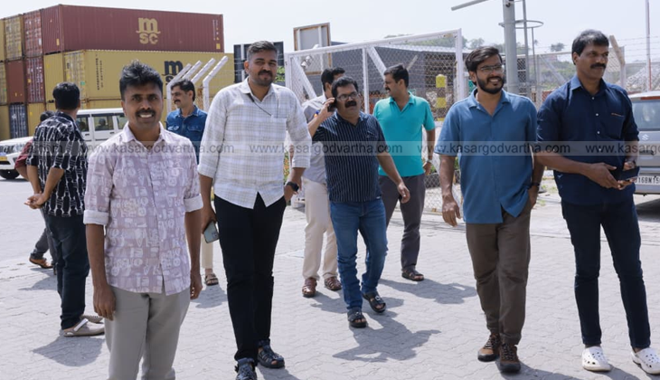 An image of the Vizhinjam International Seaport with cargo ships and cranes.