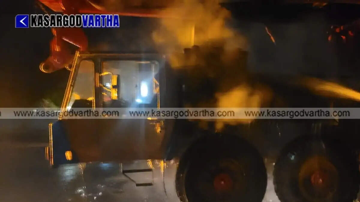 Moving 500-ton heavy crane truck catches fire in Kasaragod; major disaster averted by Fire Force.