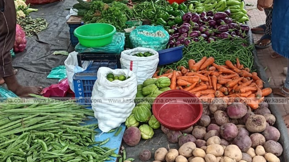 A vibrant vegetable market stall in Kasaragod town with a variety of fresh vegetables on display.