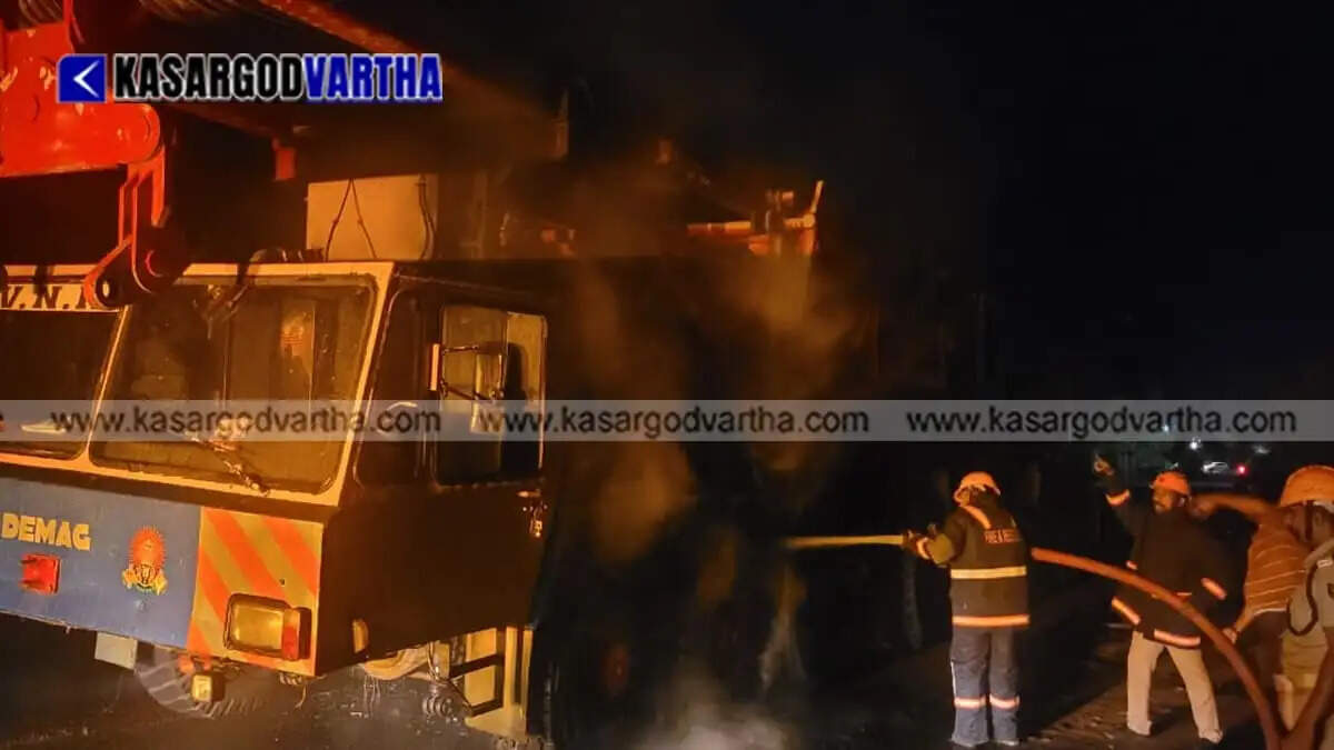 Moving 500-ton heavy crane truck catches fire in Kasaragod; major disaster averted by Fire Force.