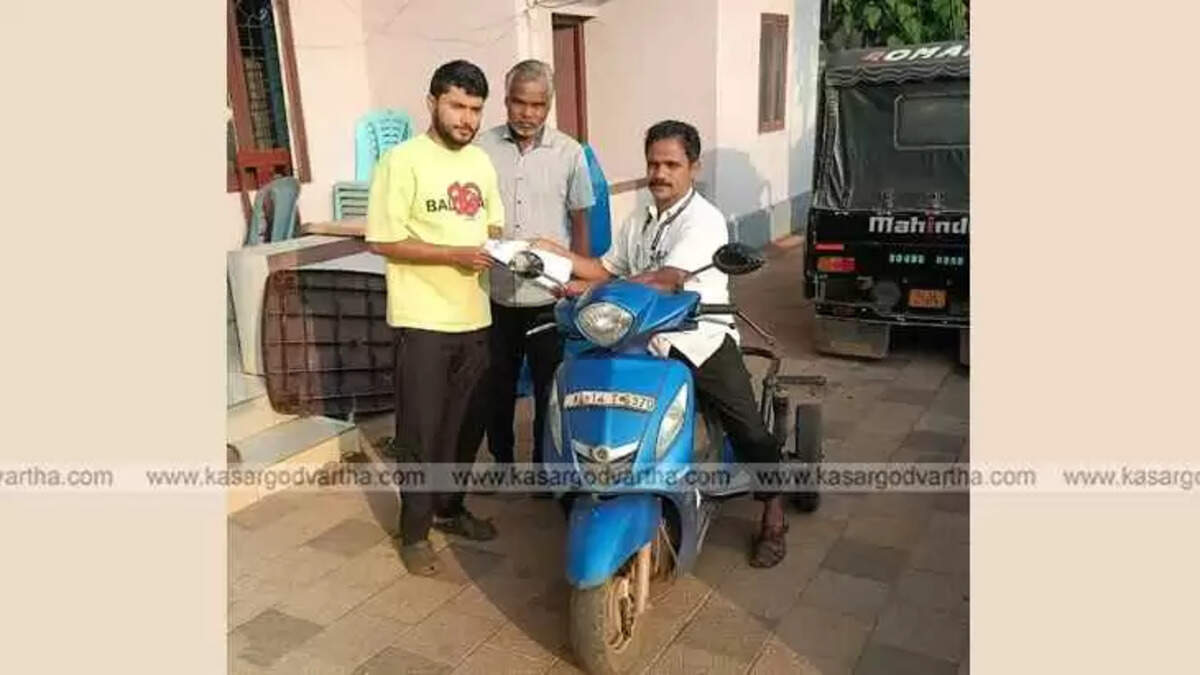 Booth Level Officer Hakeem Kambhar riding three-wheeler scooter for voter list duty.