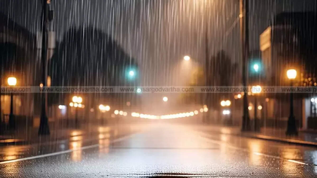 Vehicles moving on a waterlogged road during heavy rain in Kerala.