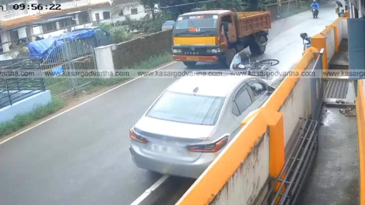 CCTV footage showing a cyclist narrowly escaping a speeding lorry in Payyanur.